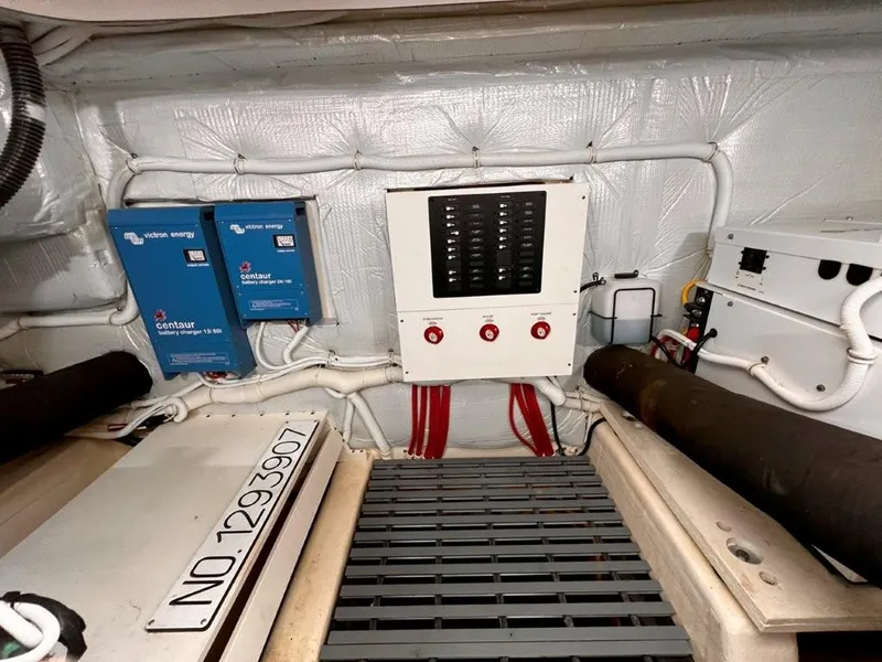 Slide: The Image of Electrical panel and battery chargers in 2019 Tiara Yachts 490 Coupe engine room. - 28