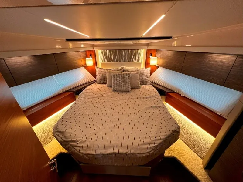 Slide: The Image of Luxurious bedroom interior of 2019 Tiara Yachts 490 Coupe with elegant lighting and cozy bedding. - 3