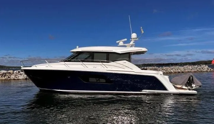 Slide: The Image of 2019 Tiara Yachts 490 Coupe on water, sleek design, clear blue sky background. - 5