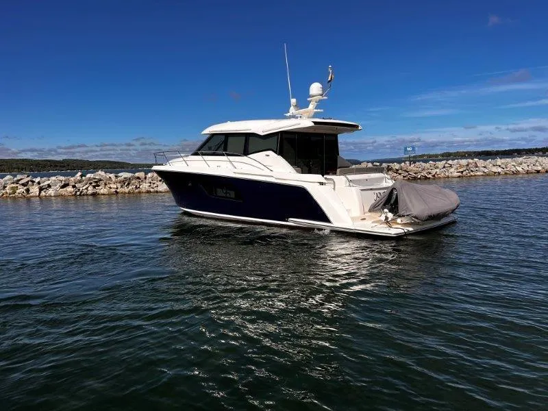 Slide: The Image of 2019 Tiara Yachts 490 Coupe on calm water, clear sky background. - 6