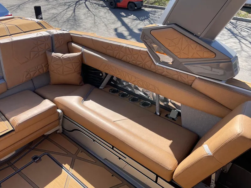 Slide: The Image of 2024 Nautique Super Air Nautique G25 Paragon interior with tan leather seating. - 10