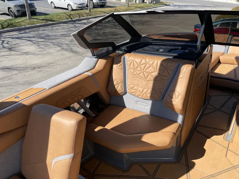 Slide: The Image of 2024 Nautique Super Air Nautique G25 Paragon interior with tan leather seating. - 11