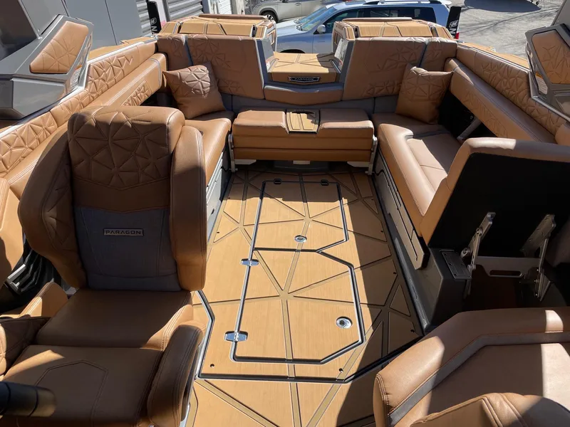Slide: The Image of 2024 Nautique Super Air Nautique G25 Paragon interior with luxurious tan seating. - 13