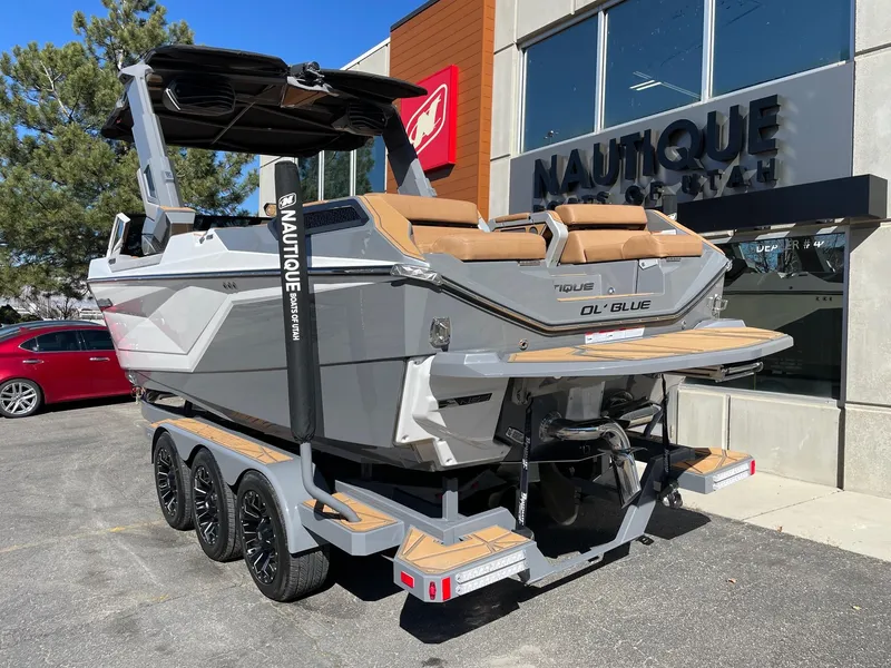 Slide: The Image of 2024 Nautique Super Air Nautique G25 Paragon boat on trailer outside dealership. - 3