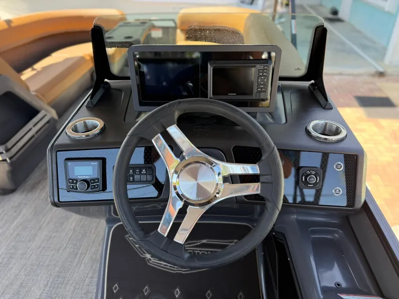 Slide: The Image of 2025 Bennington 24 MSB boat dashboard with steering wheel and modern controls. - 11