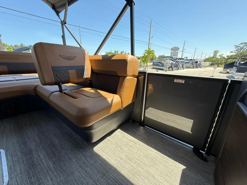 Slide: The Image of 2025 Bennington 24 MSB boat interior with brown seating and modern design. - 13