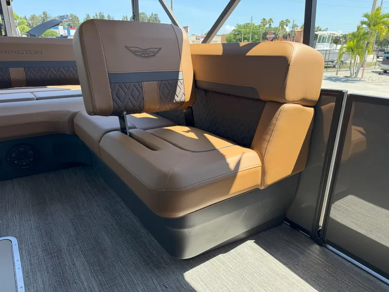 Slide: The Image of 2025 Bennington 24 MSB boat interior with luxurious brown seating and stylish design. - 15