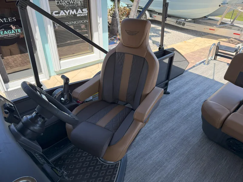Slide: The Image of Captain's chair on 2025 Bennington 24 MSB boat, featuring luxurious brown and black upholstery. - 16