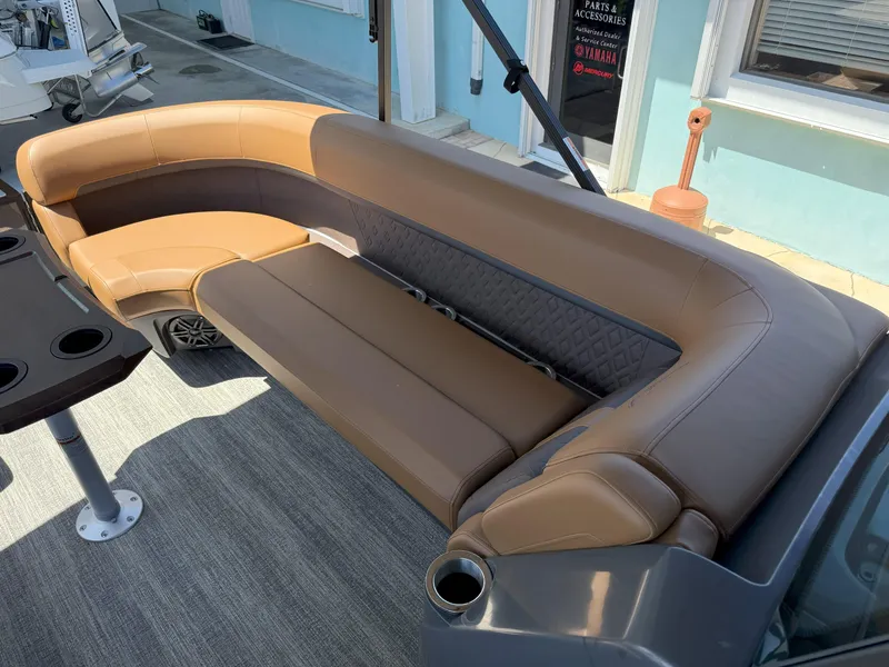 Slide: The Image of 2025 Bennington 24 MSB boat interior with brown leather seating and cup holders. - 22