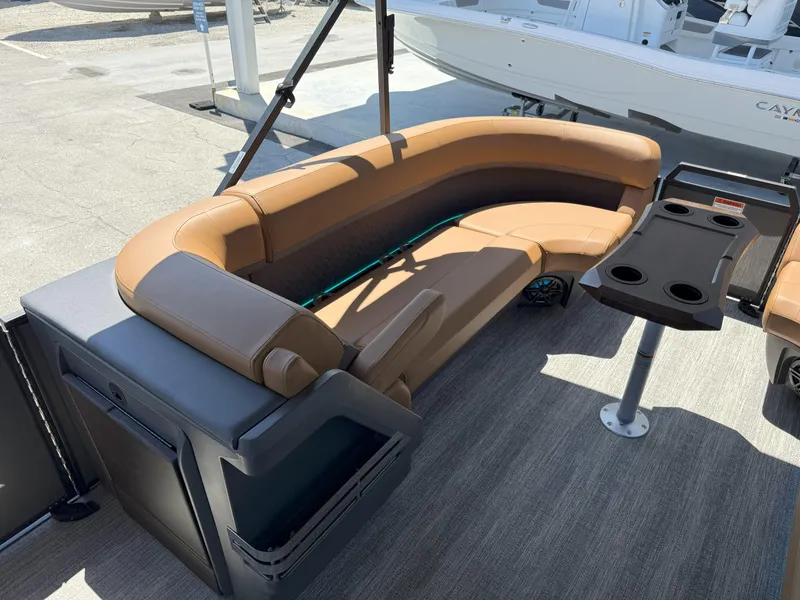 Slide: The Image of 2025 Bennington 24 MSB boat interior with tan seating and a black table. - 23