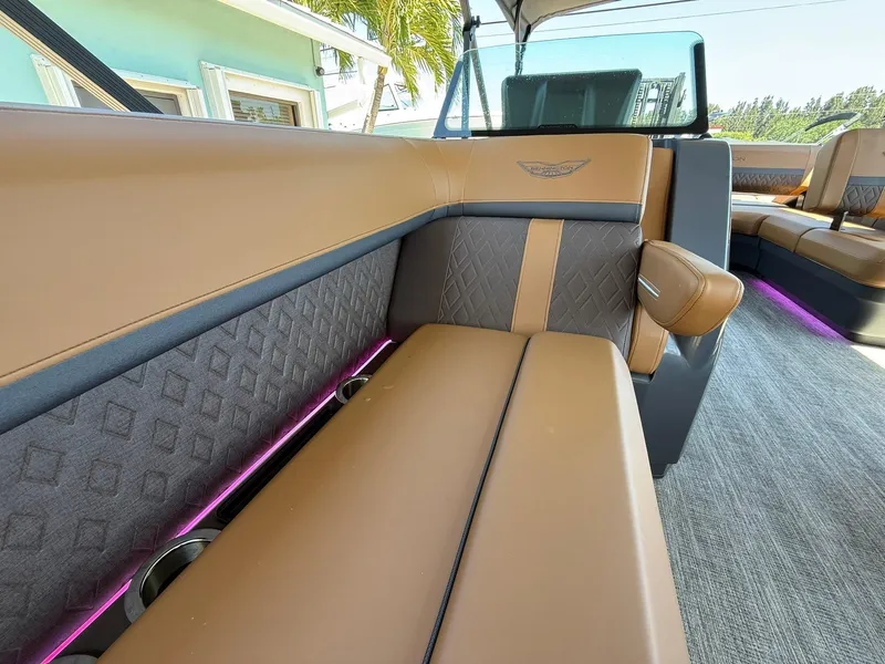 Slide: The Image of Luxurious interior of 2025 Bennington 24 MSB boat with tan and gray seating. - 25