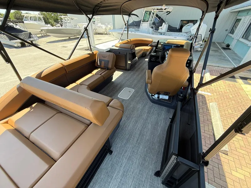 Slide: The Image of 2025 Bennington 24 MSB pontoon boat with spacious seating and modern interior design. - 7