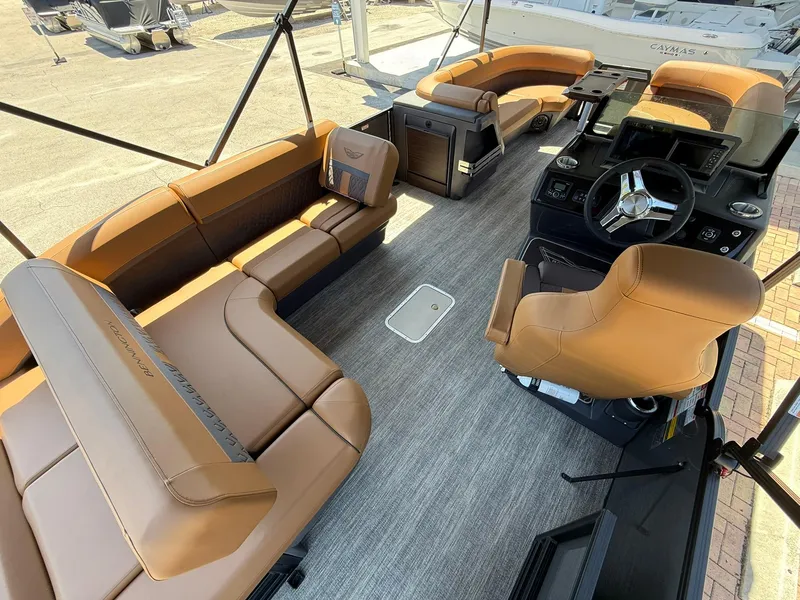 Slide: The Image of 2025 Bennington 24 MSB boat interior with tan seating and modern helm. - 8