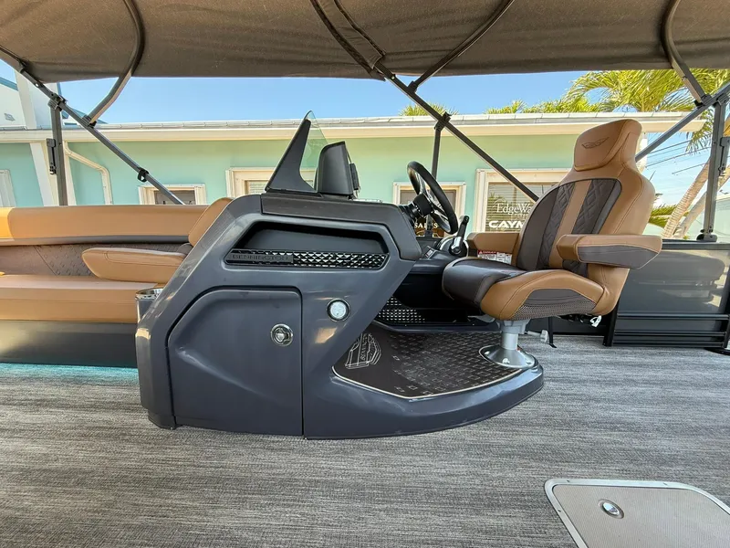Slide: The Image of 2025 Bennington 24 MSB boat interior with captain's chair and control console. - 9