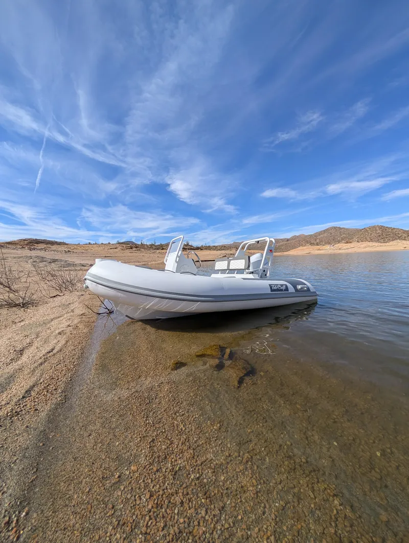 Slide: The Image of Tide Craft Beaver 10 boat on sandy shore under blue sky, 2025 model. - 2