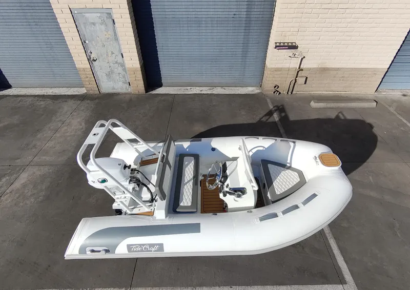 Slide: The Image of Tide Craft Beaver 10 boat, 2025 model, parked near storage units. - 5