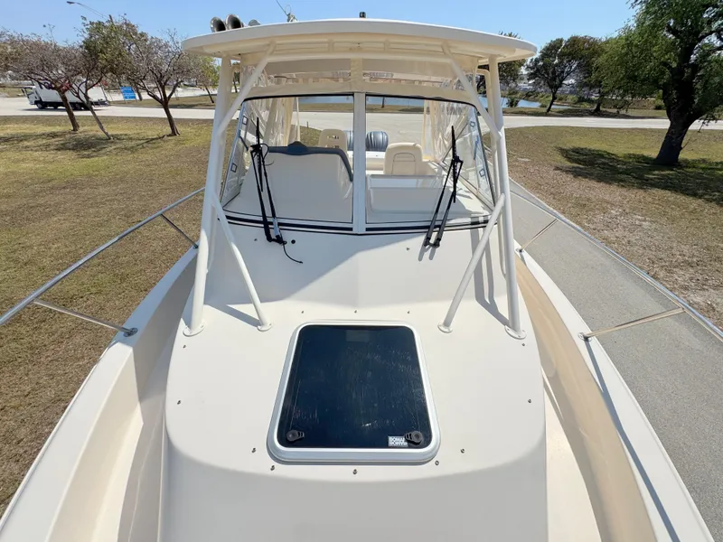 Slide: The Image of 2022 Grady-White Marlin 300 boat, front view, parked on a sunny day. - 10