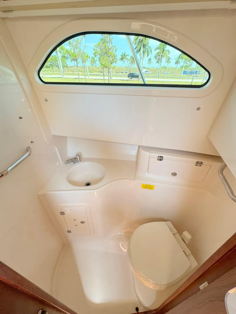 Slide: The Image of 2022 Grady-White Marlin 300 boat interior with sink and toilet. - 20