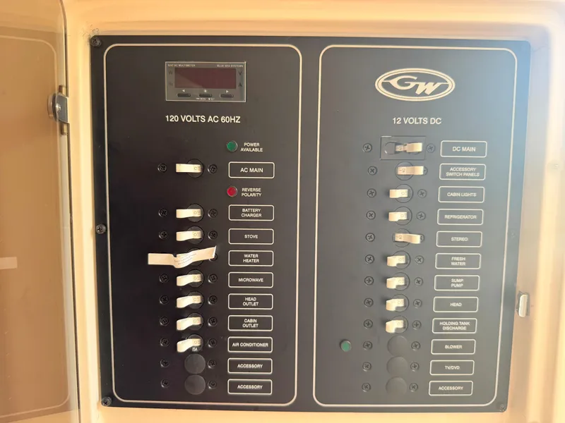Slide: The Image of Electrical panel of 2022 Grady-White Marlin 300 boat, showing AC and DC switches. - 22
