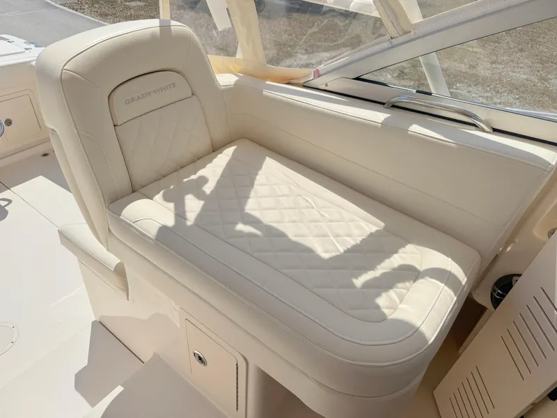 Slide: The Image of 2022 Grady-White Marlin 300 boat seat with quilted upholstery in sunlight. - 27