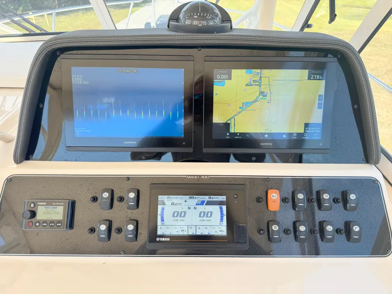 Slide: The Image of Dashboard of 2022 Grady-White Marlin 300 with navigation and control displays. - 30