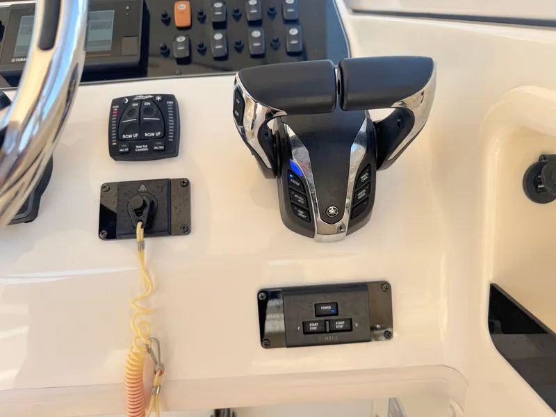 Slide: The Image of Control panel of 2022 Grady-White Marlin 300 boat with throttle and switches. - 32