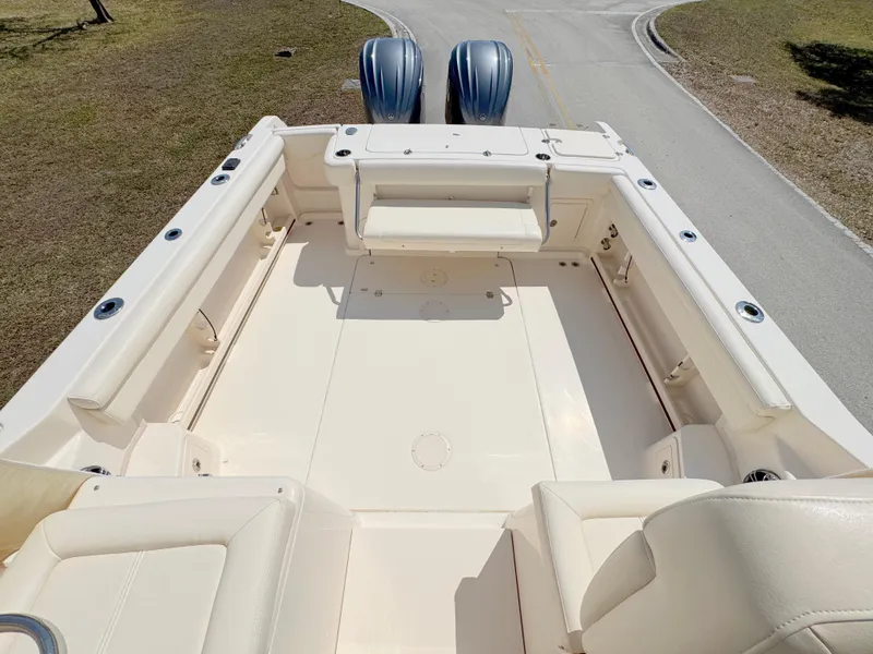 Slide: The Image of 2022 Grady-White Marlin 300 boat deck with seating and twin engines. - 34
