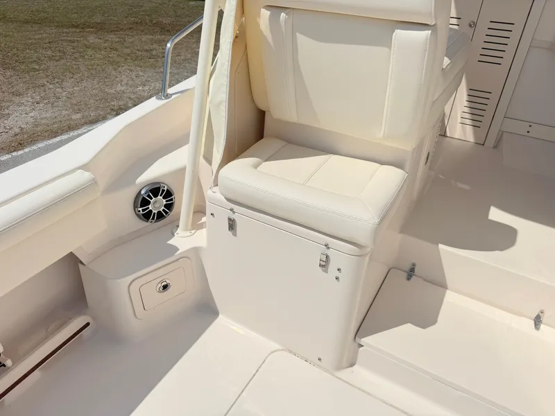 Slide: The Image of 2022 Grady-White Marlin 300 boat interior with cushioned seating and storage. - 36