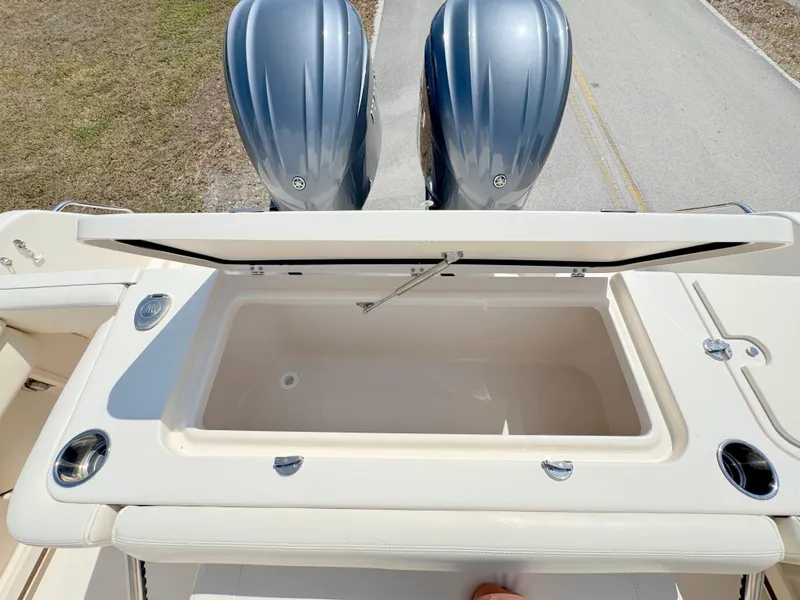 Slide: The Image of 2022 Grady-White Marlin 300 boat with open storage compartment and dual outboard engines. - 42
