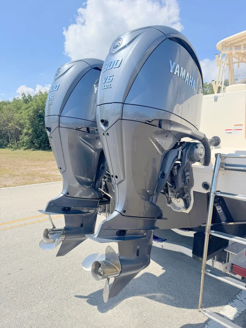 Slide: The Image of 2022 Grady-White Marlin 300 with dual Yamaha outboard engines, parked outdoors. - 47