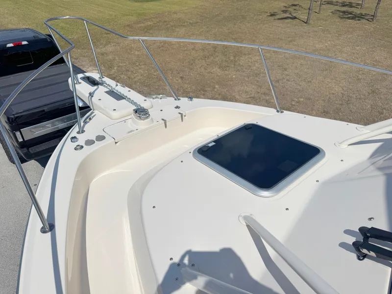 Slide: The Image of 2022 Grady-White Marlin 300 boat deck with hatch and railing, parked on grass. - 8