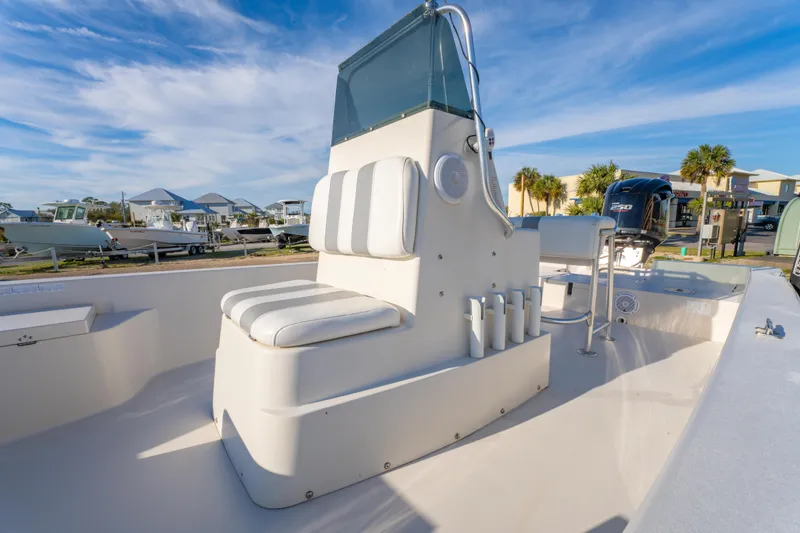 Slide: The Image of 2001 Pathfinder 2400-V boat interior with seating and console, under a clear blue sky. - 14
