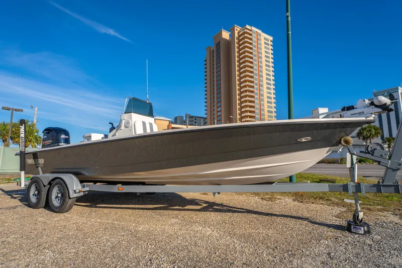 Slide: The Image of 2001 Pathfinder 2400-V boat on trailer, urban background, clear sky. - 4