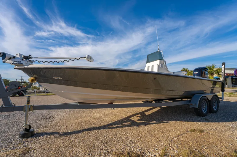 Slide: The Image of 2001 Pathfinder 2400-V boat on trailer under clear blue sky. - 7