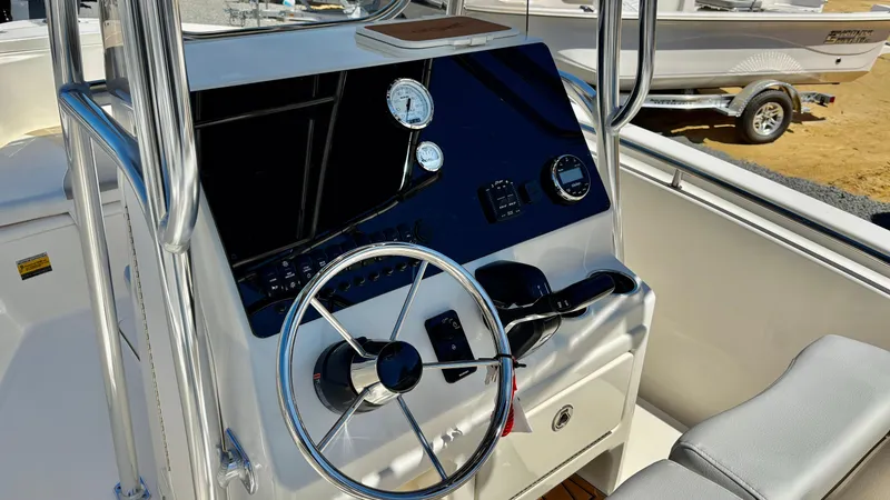 Slide: The Image of 2025 Bulls Bay 230CC boat console with steering wheel and gauges. - 11