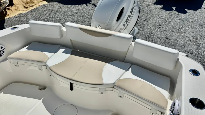 Slide: The Image of 2025 Bulls Bay 230CC boat with cushioned seating and outboard motor. - 12