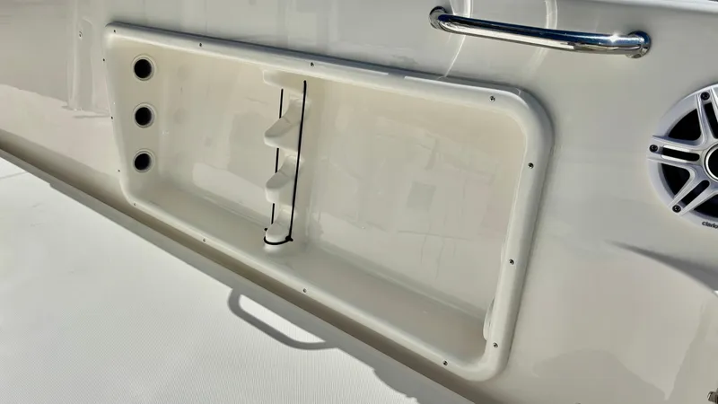 Slide: The Image of 2025 Bulls Bay 230CC boat interior detail with speaker and storage compartment. - 13