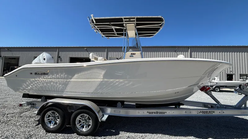Slide: The Image of 2025 Bulls Bay 230CC boat on trailer, side view, sunny day. - 4