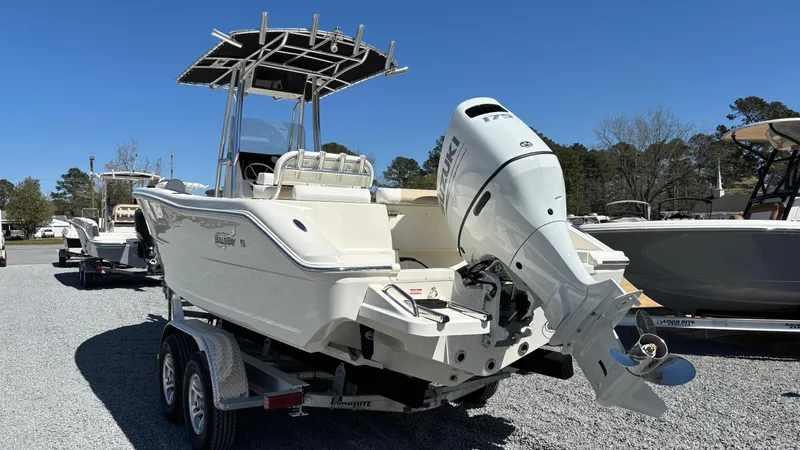 Slide: The Image of 2025 Bulls Bay 230CC boat on trailer, featuring a powerful outboard motor. - 5