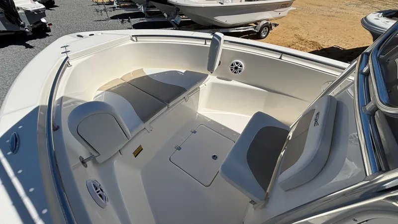 Slide: The Image of 2025 Bulls Bay 230CC boat interior with cushioned seating and storage compartments. - 7