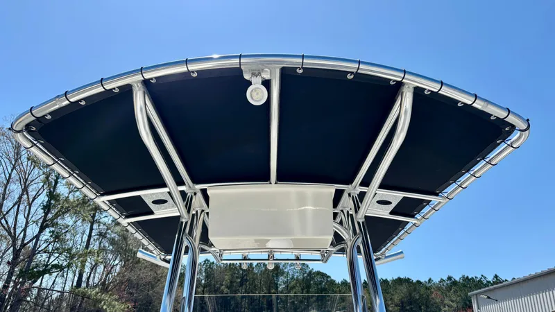 Slide: The Image of 2025 Bulls Bay 230CC boat with T-top against clear blue sky. - 9