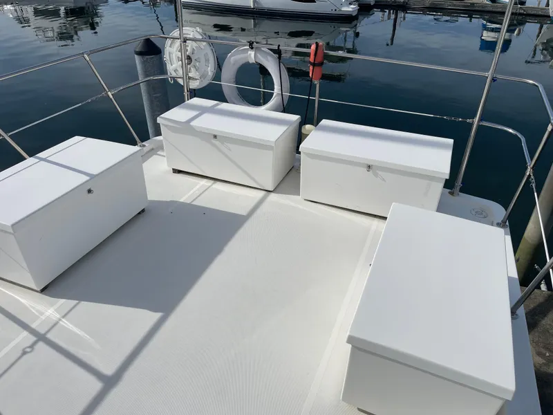 Slide: The Image of Canoe Cove 50 Pilothouse Yacht deck with white storage boxes, 2002 model. - 10