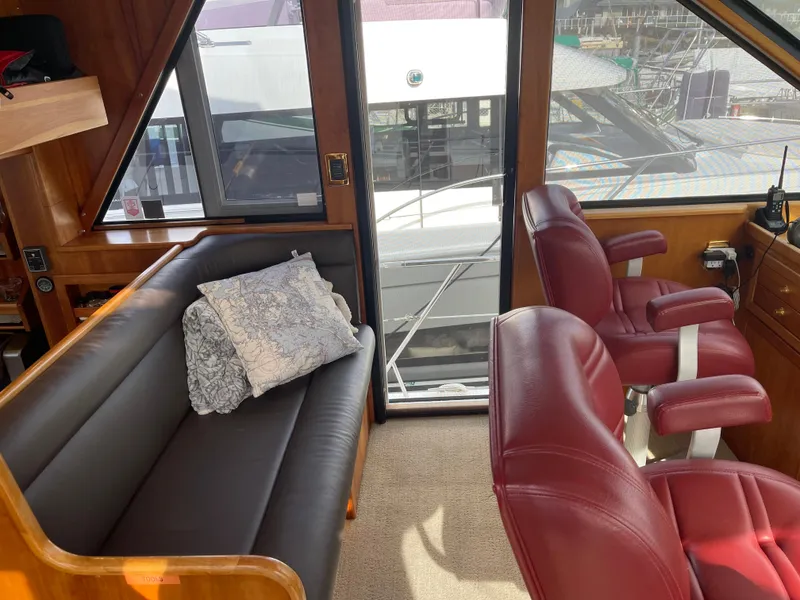 Slide: The Image of Pilothouse interior of 2002 Canoe Cove 50 Yacht with leather seating and large windows. - 17