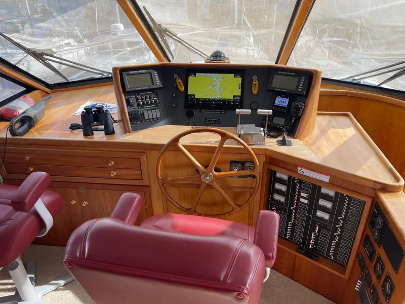Slide: The Image of Pilothouse of 2002 Canoe Cove 50 Pilothouse Luxury Yacht with navigation equipment and wooden steering wheel. - 19