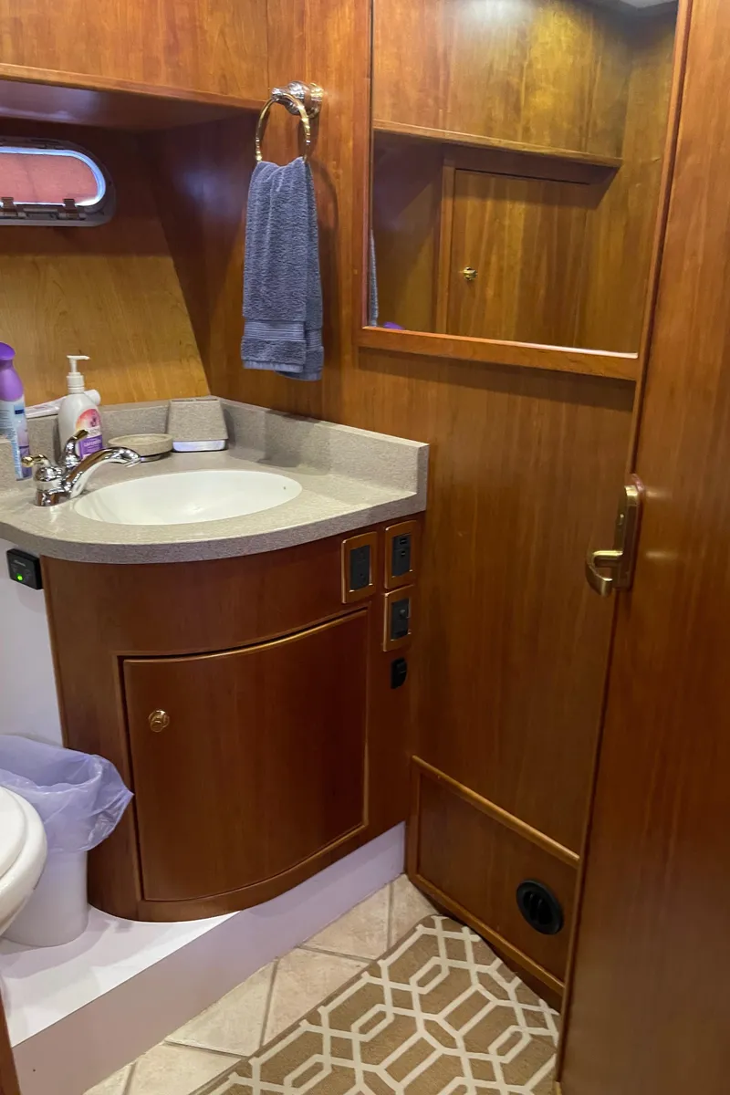 Slide: The Image of Luxurious bathroom in 2002 Canoe Cove 50 Pilothouse Yacht with wooden cabinetry and modern fixtures. - 20
