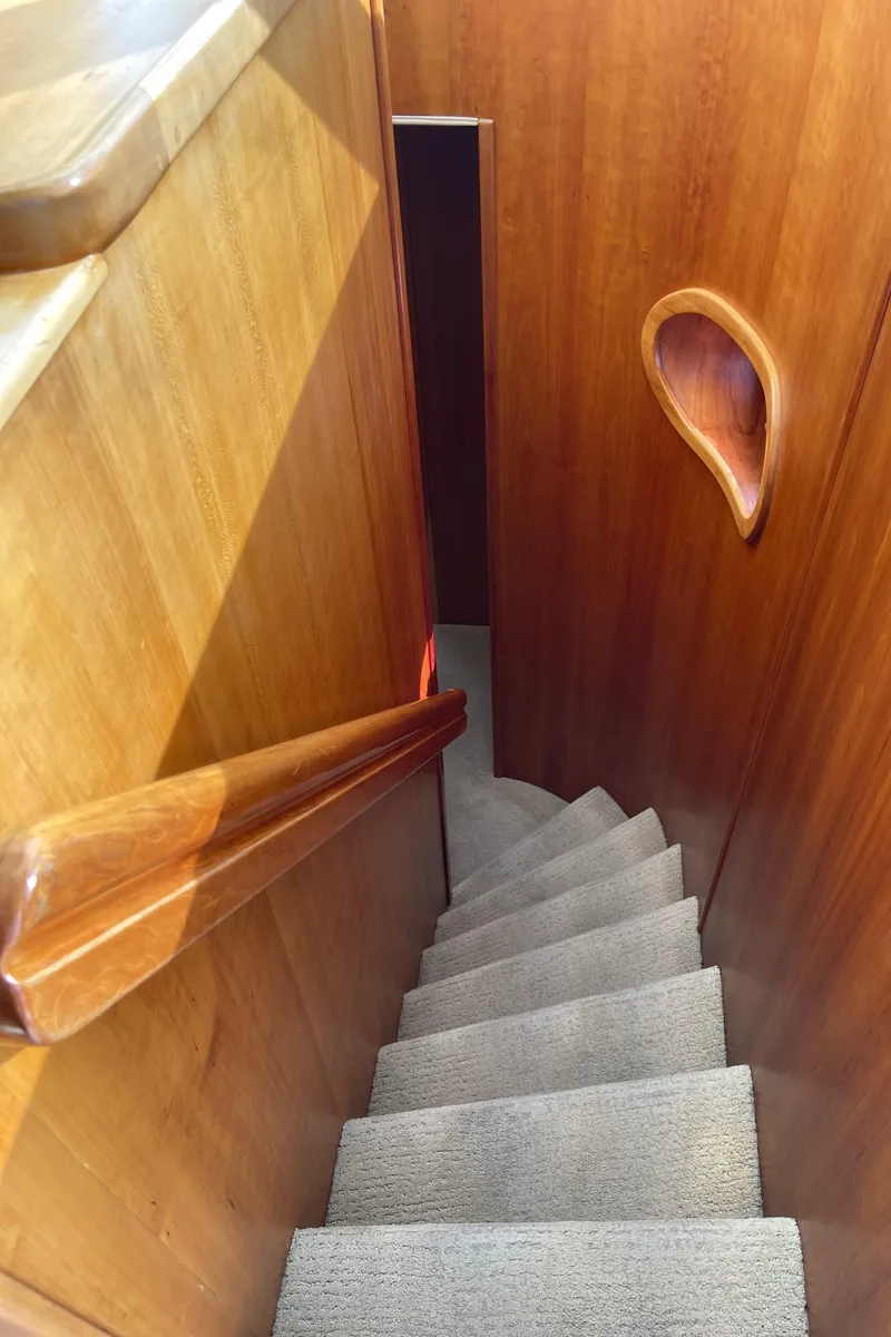 Slide: The Image of Staircase inside 2002 Canoe Cove 50 Pilothouse Luxury Yacht with wooden paneling. - 21