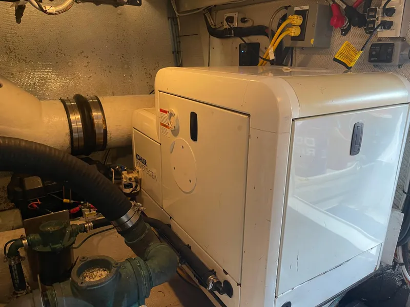 Slide: The Image of Engine room of 2002 Canoe Cove 50 Pilothouse Luxury Yacht, featuring generator and equipment. - 25