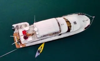 Slide: The Image of Aerial view of 2002 Canoe Cove 50 Pilothouse Luxury Yacht on water. - 27