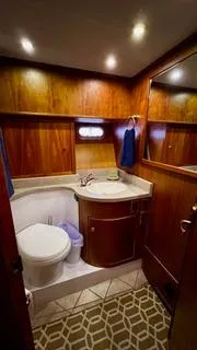 Slide: The Image of 2002 Canoe Cove 50 Pilothouse Yacht bathroom with wood paneling and modern fixtures. - 29
