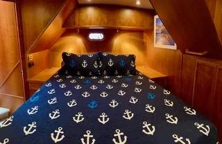 Slide: The Image of Luxurious bedroom in 2002 Canoe Cove 50 Pilothouse Yacht with anchor-themed bedding. - 30